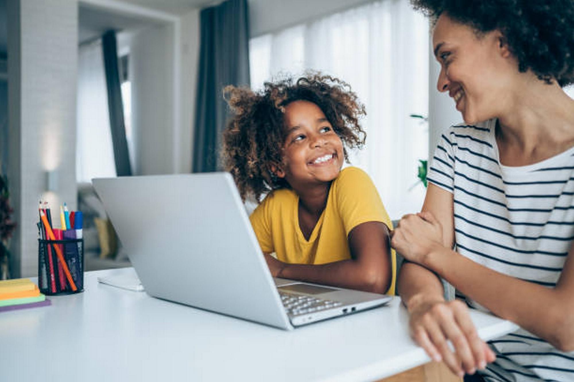 Mom with daughter using laptop